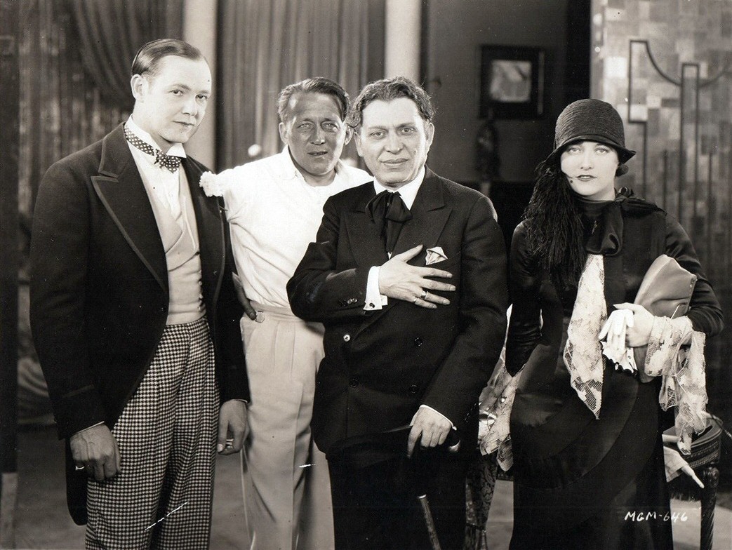 1926. On the set of 'Paris' with Charles Ray, director Goulding, and visiting NYC producer Morris Gest.