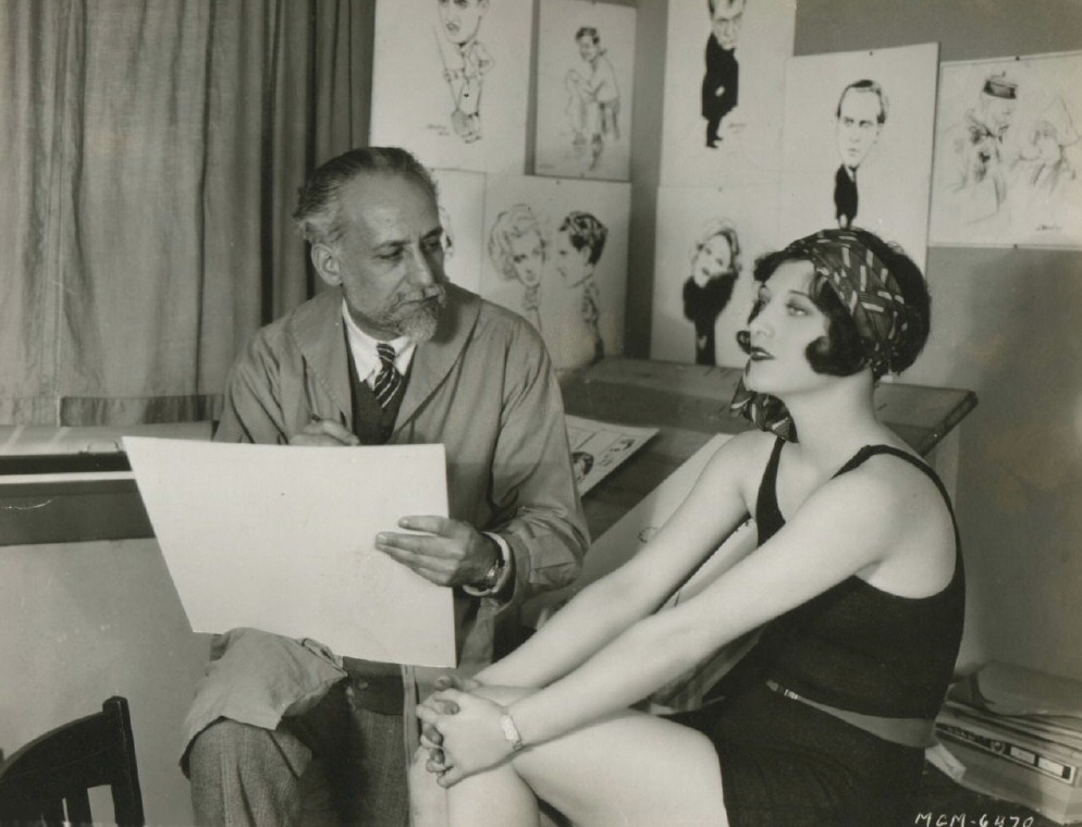 1927. Being sketched by vaudevillian and cartoonist Bert Levy.