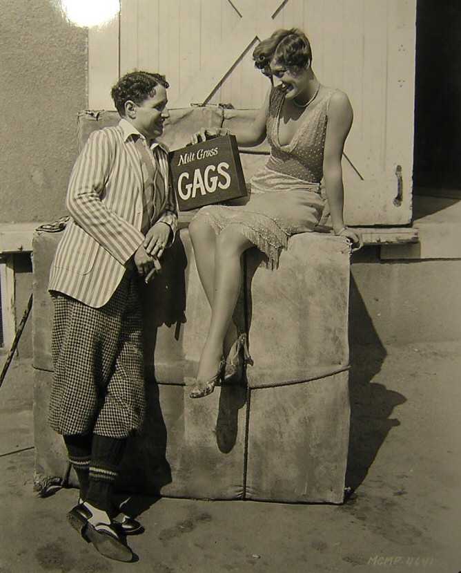 1928. On the set of 'Four Walls' with comic-strip artist Milt Gross.