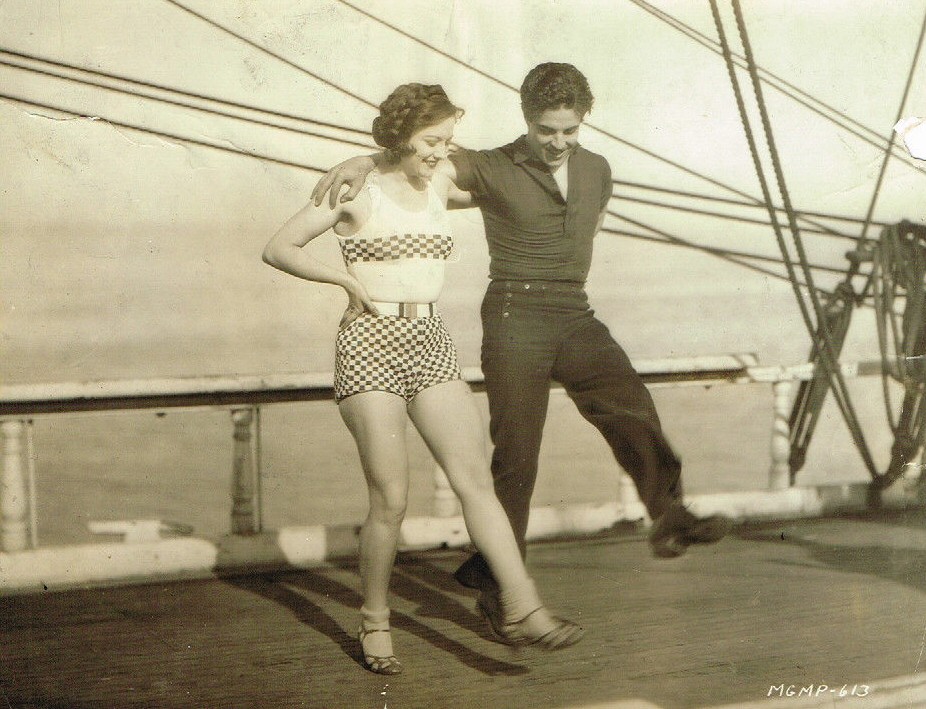 1928. On the set of 'Across to Singapore,' with Ramon Novarro.