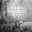 August 14, 1929. One construction shot and two shots of the 'Hollywood Revue of 1929' premiere at the Astor Theatre in NYC. With live girls on the billboard.