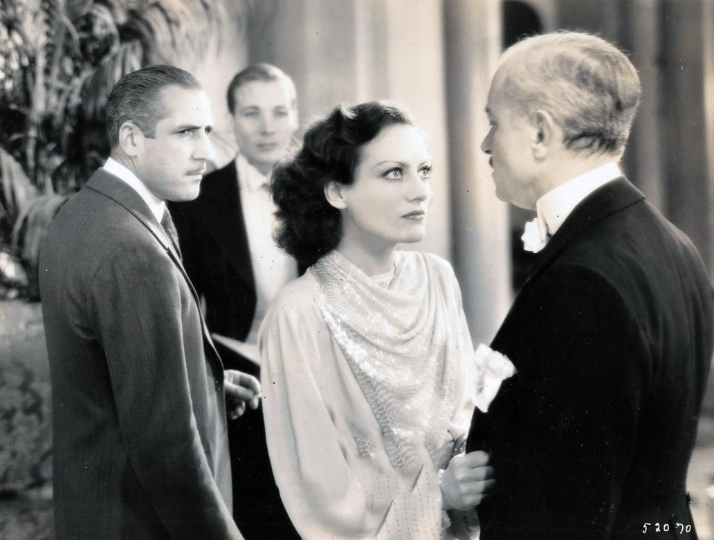 1930. 'Paid.' With John Miljan (left) and Kent Douglass (background).