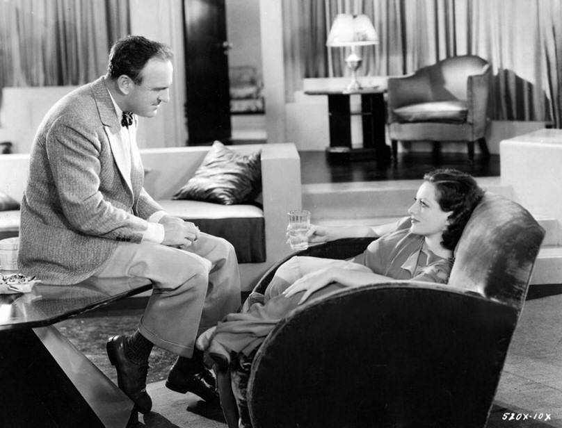 1930. On the set of 'Paid' with director Sam Wood.