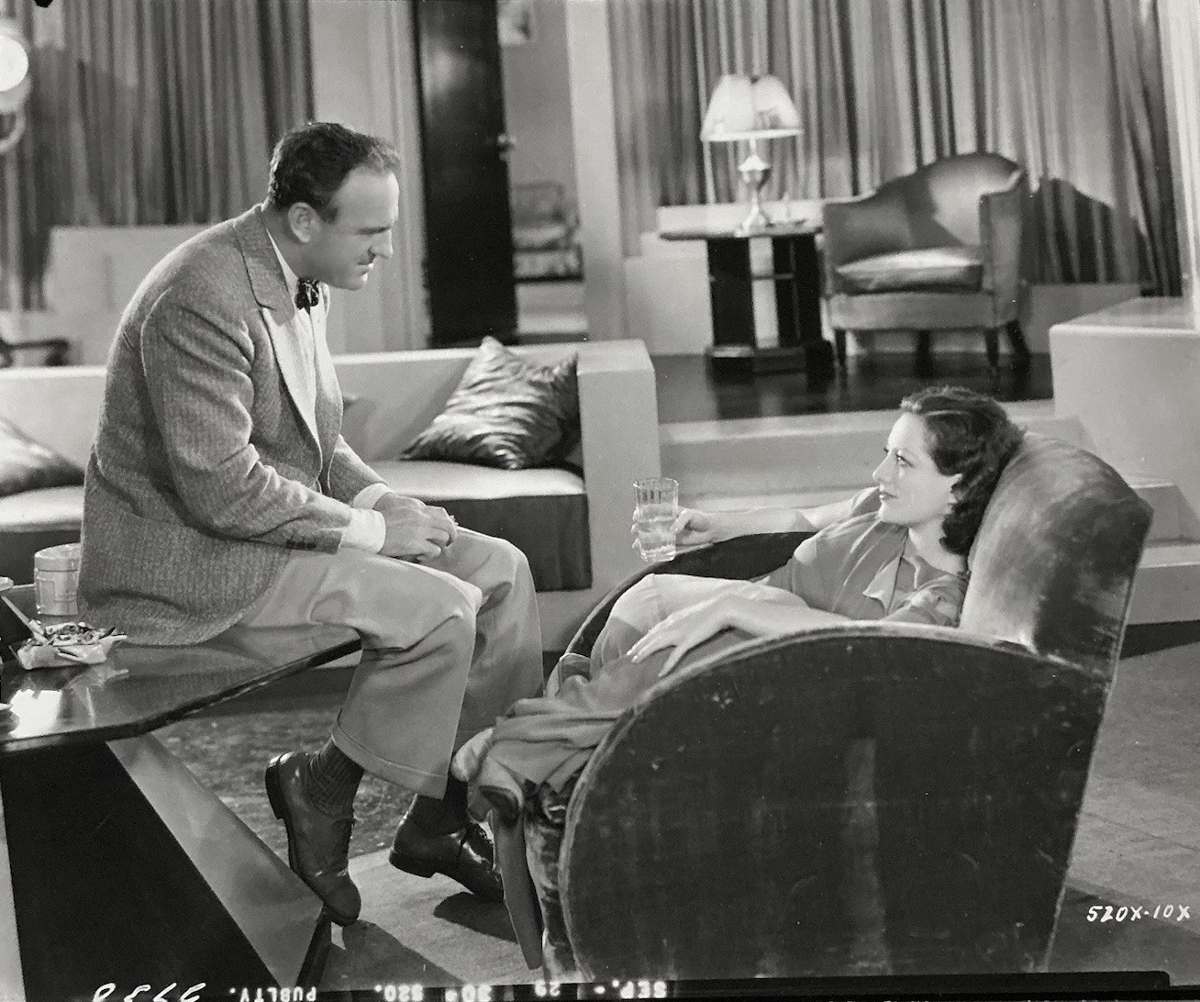 1930. On the set of 'Paid' with director Sam Wood.