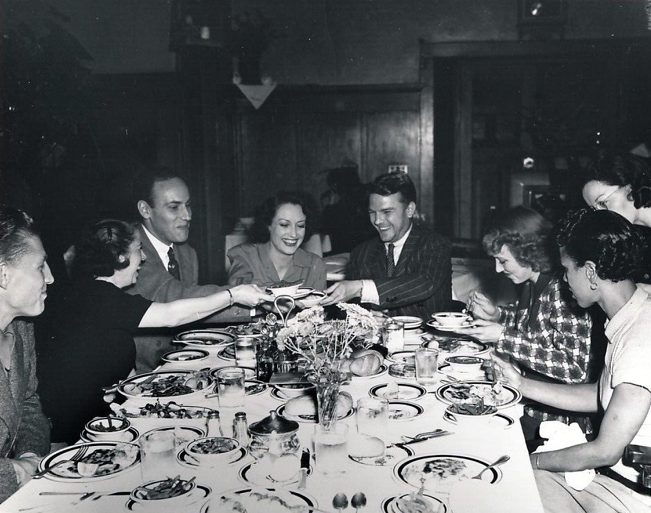 Circa 1938. With hairstylist Guilaroff (seated right of Joan) at the MGM commissary.