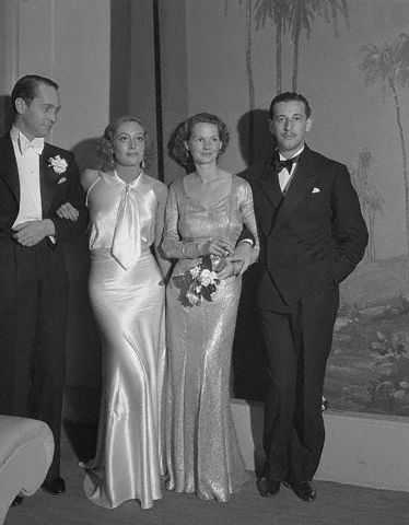 With Franchot Tone, unknown, and Adrian.