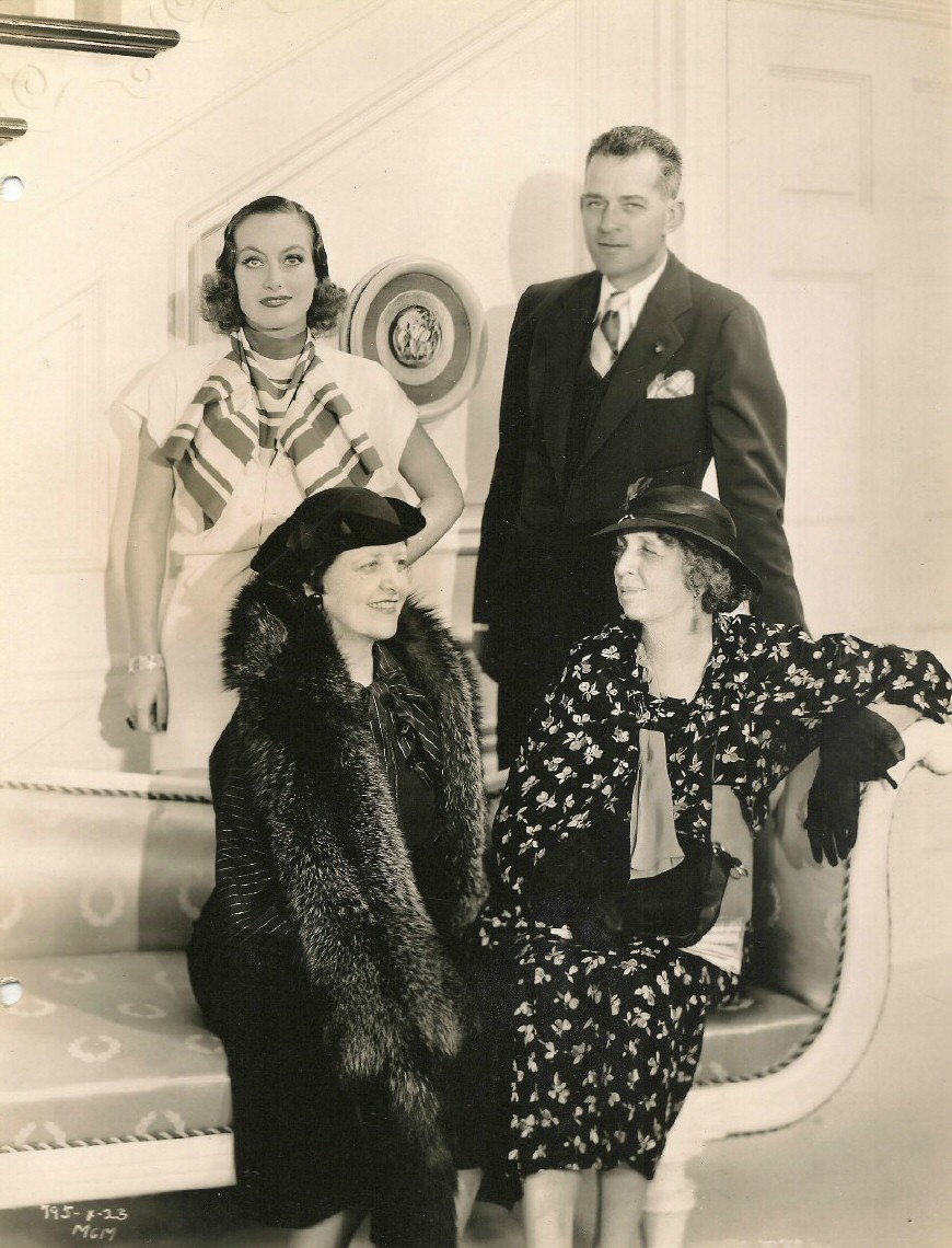 1934. On the set of 'Forsaking All Others' with director Van Dyke and their mothers.