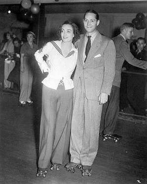 Circa 1935. With husband Franchot Tone at a Ginger Rogers skate party.