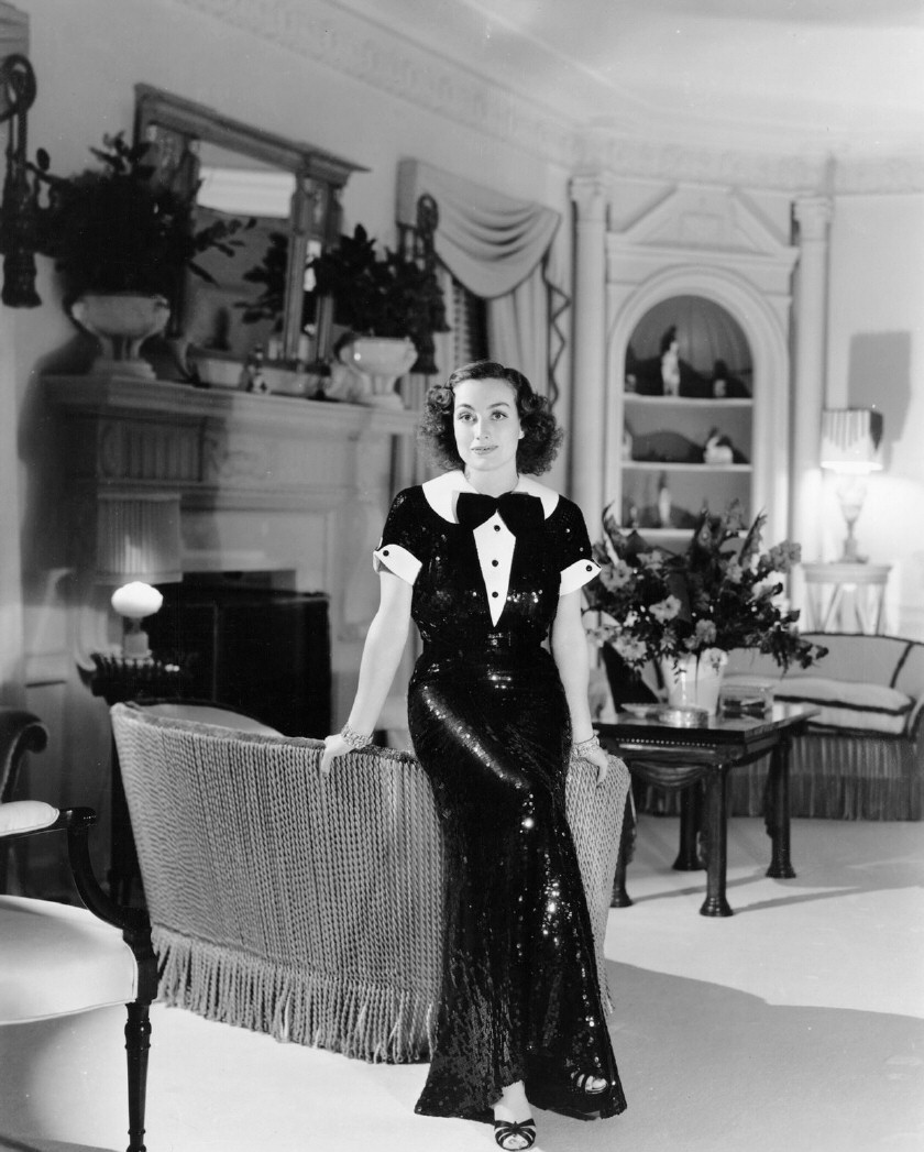 1936 at home, with dress by Hattie Carnegie.