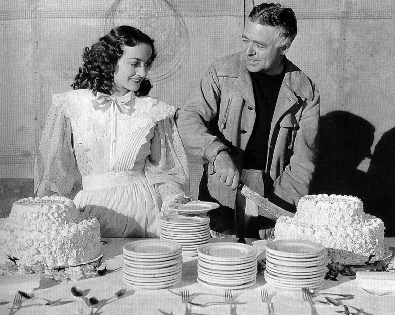 1936. On the set of 'The Gorgeous Hussy' with director Clarence Brown.