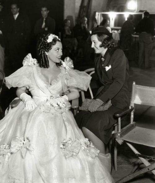 1936. On the set of 'Gorgeous Hussy' with Barbara Stanwyck.