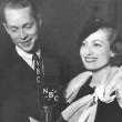 Joan and Franchot Tone at a radio show. Based on her outfit, probably 1933.