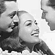 1937. 'The Bride Wore Red' publicity shot. With Robert Young, left, and Franchot Tone.