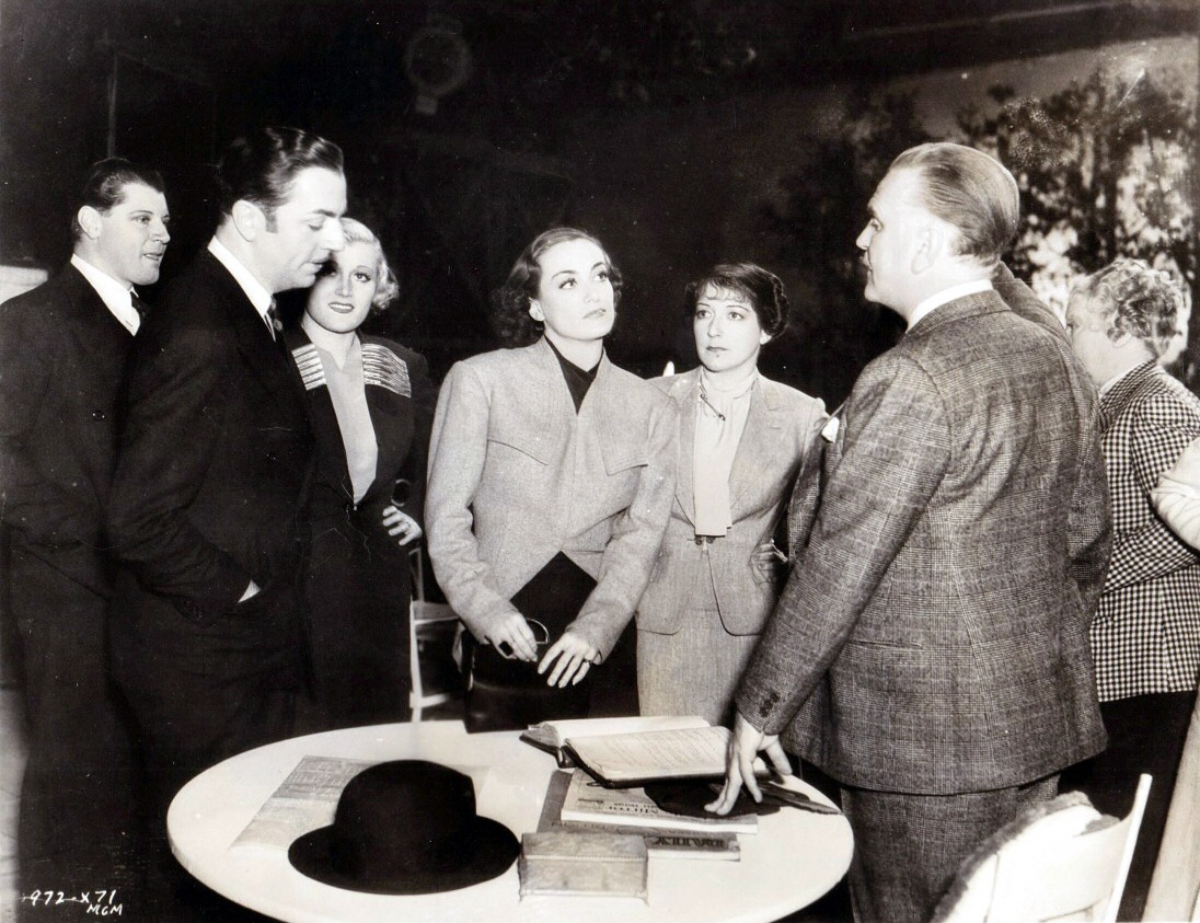 1937. On the set of 'The Last of Mrs. Cheyney' with cast members.