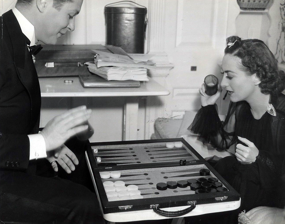 On the set of 'The Last of Mrs. Cheyney' with Robert Montgomery. Photo by Bud Graybill.