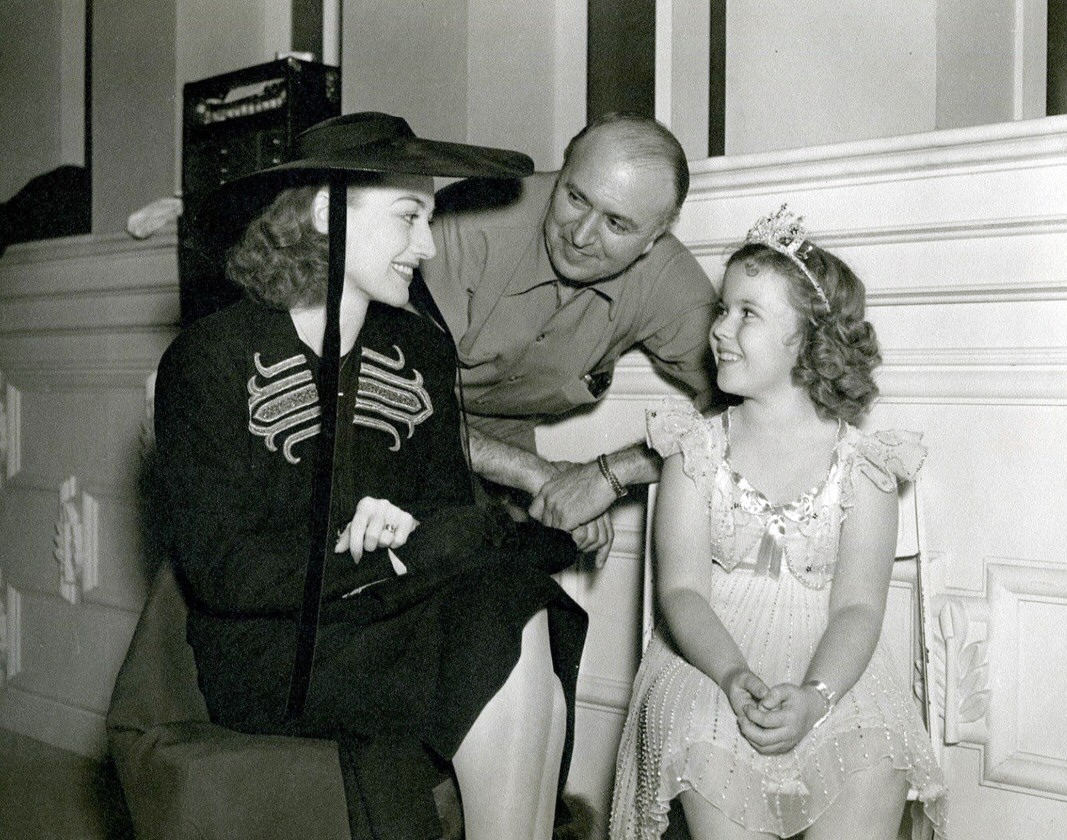 1938. With director Irving Cummings and Shirley Temple on the set of 'Little Miss Broadway.'
