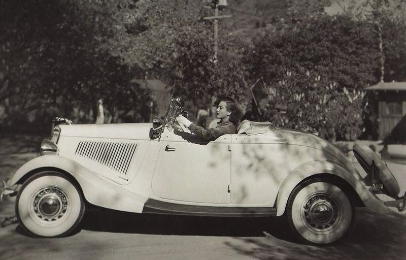 In her 1934 Ford Roadster.