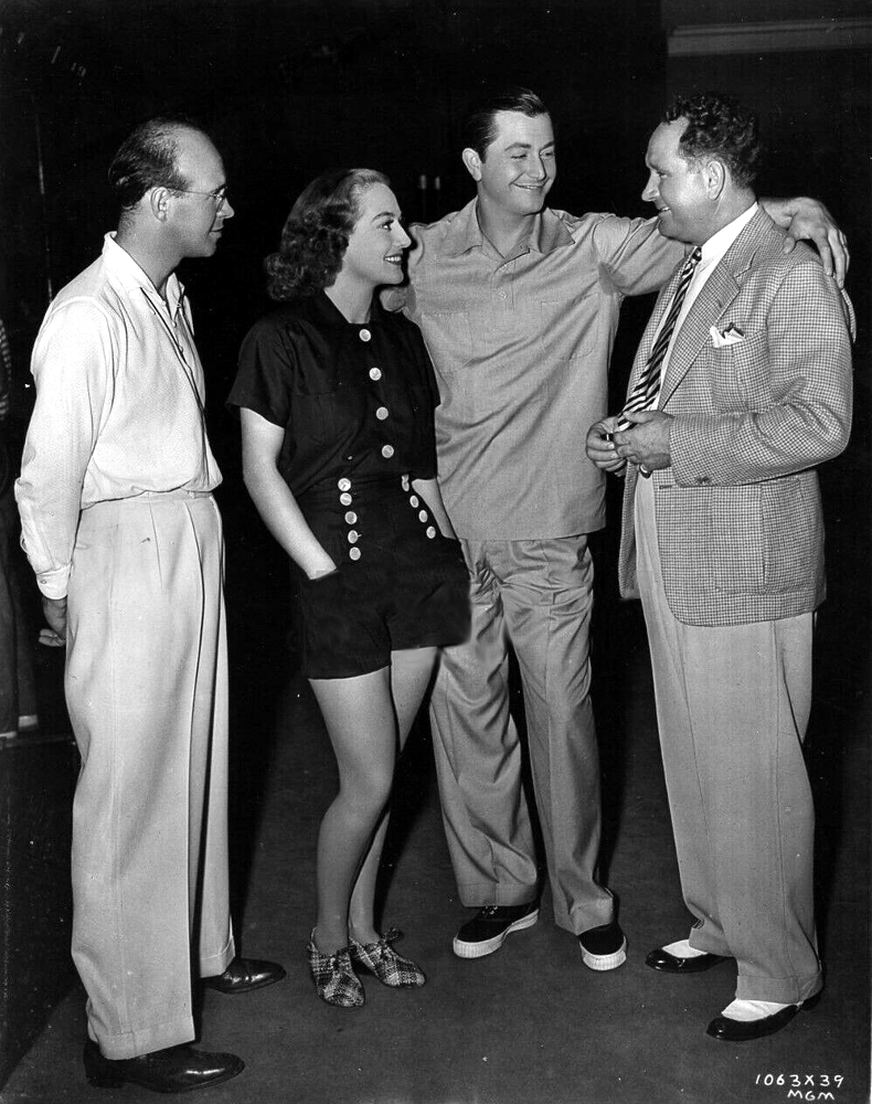 1938. On the set of 'The Shining Hour.' With cameraman George Folsey, Robert Young, and director Frank Borzage.