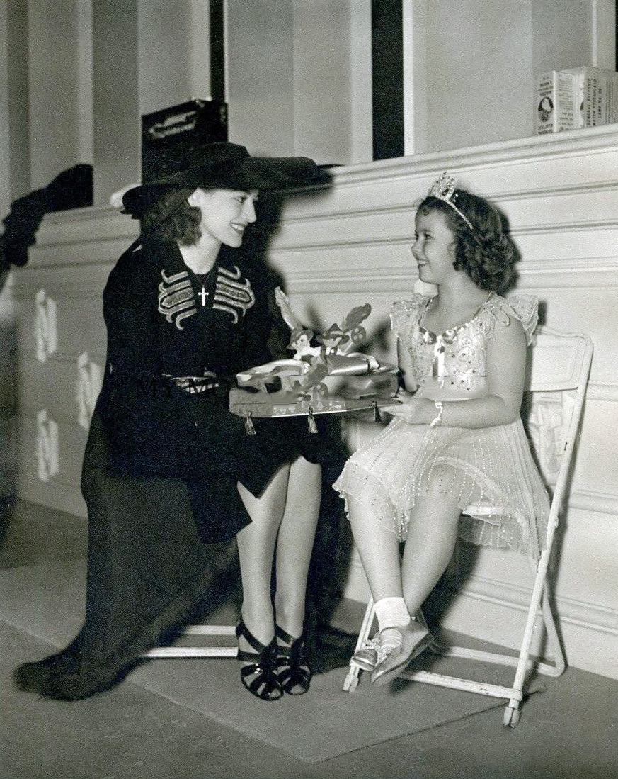 1938. On the set of 'Little Miss Broadway' with Shirley Temple.