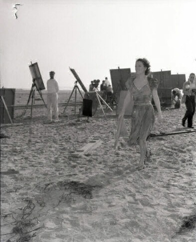 1940. Candid on the set of 'Strange Cargo.'