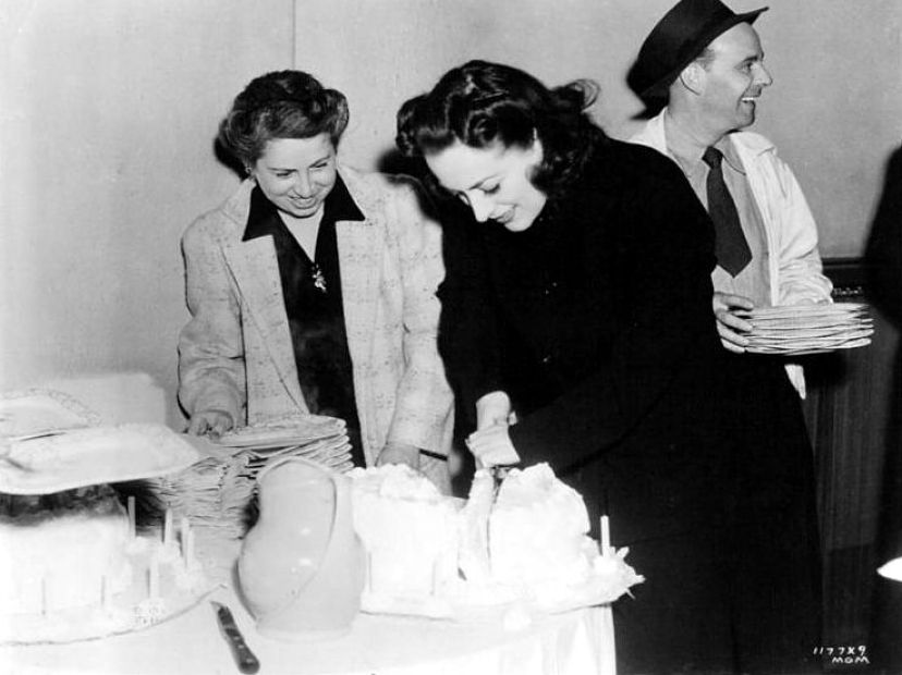 1941. On the set of 'A Woman's Face' with wardrobe woman Jean Berg.