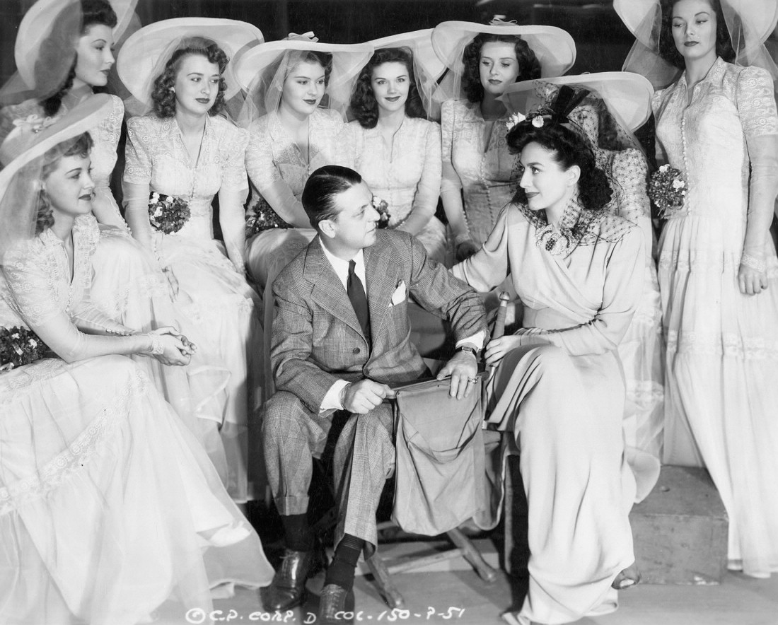 1942. 'They All Kissed the Bride.' With director Hall and starlets.