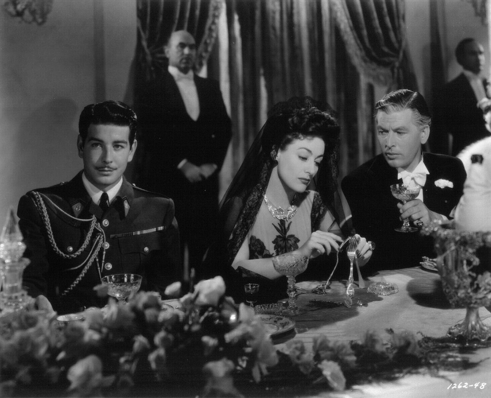 1942. 'Reunion in France.' With Philip Dorn (right).