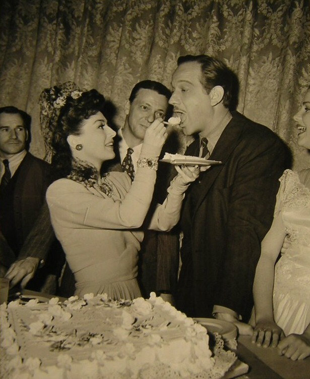 1942. On the set of 'They All Kissed the Bride' with Melvyn Douglas.