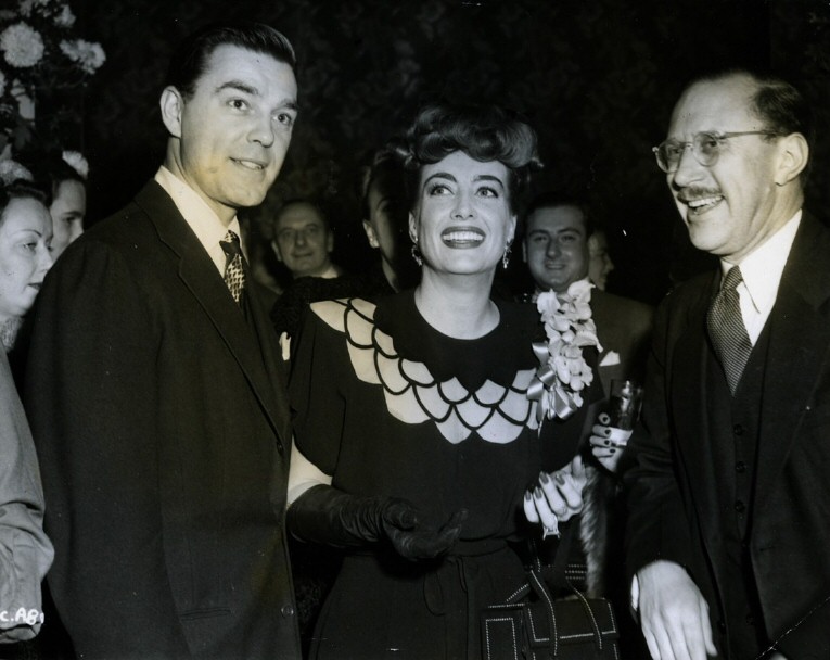 1945. Warners reception for Joan at NYC's Sherry-Netherland hotel. With husband Phillip Terry, left, and Willard Pluthner.