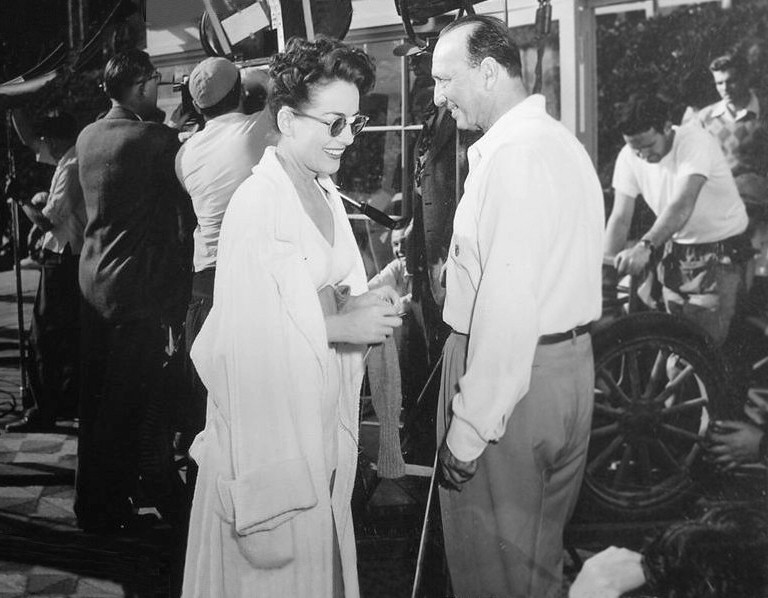 1944. On the set of 'Mildred Pierce' with director Curtiz.