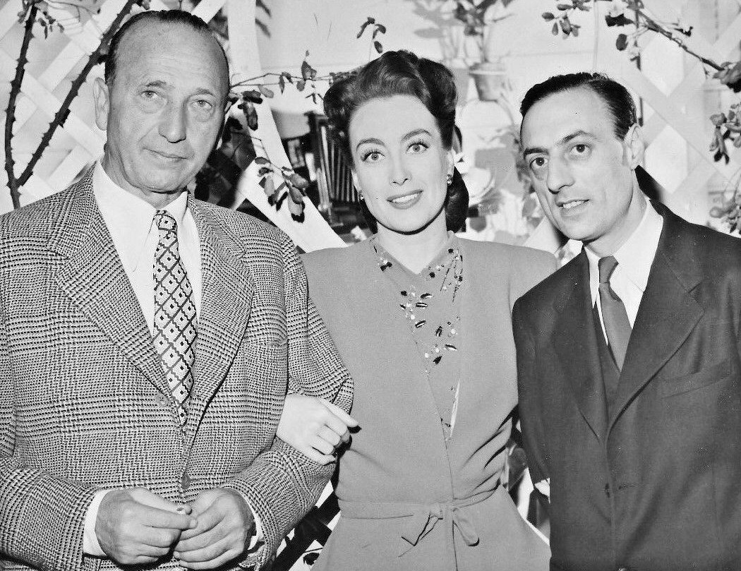 February 1945. On the set of 'Mildred Pierce' with director Curtiz and French Underground publisher Stephen Pizella.