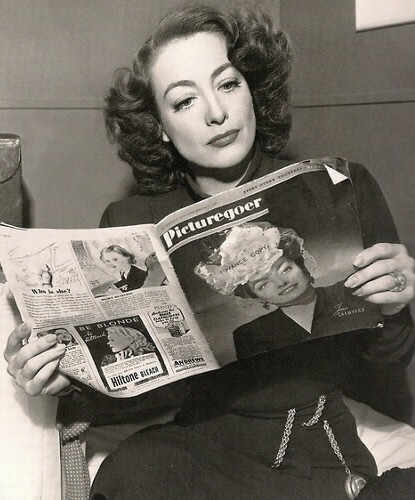 1946. On the set of 'Humoresque' with a 2/6/46 'Picturegoer' featuring herself on the cover.