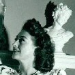 1946. Joan at home, gazing up at...herself!