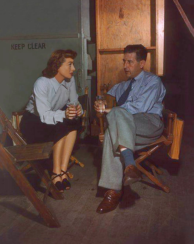 1947. On the set of 'Possessed' with director Curtis Bernhardt.