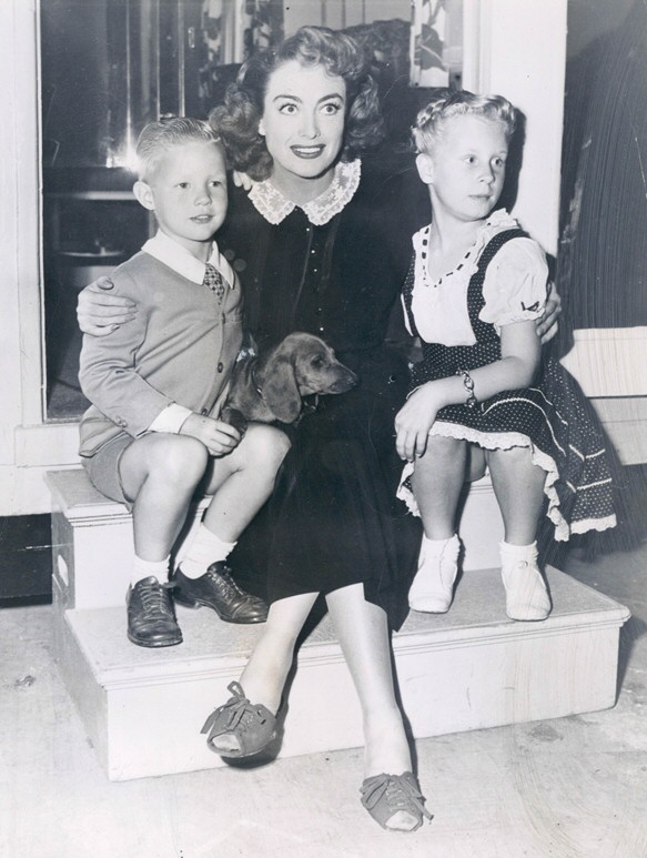 1947. On the set of 'Daisy Kenyon' with Christina and Christopher.