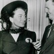 May 1948. With the detective who returned her $50,000 brooch after she lost it at Slapsy Maxie's. Includes press snipe with full description.