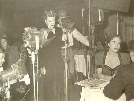 1950. On the set of 'Damned Don't Cry,' with singer Marion Morgan.