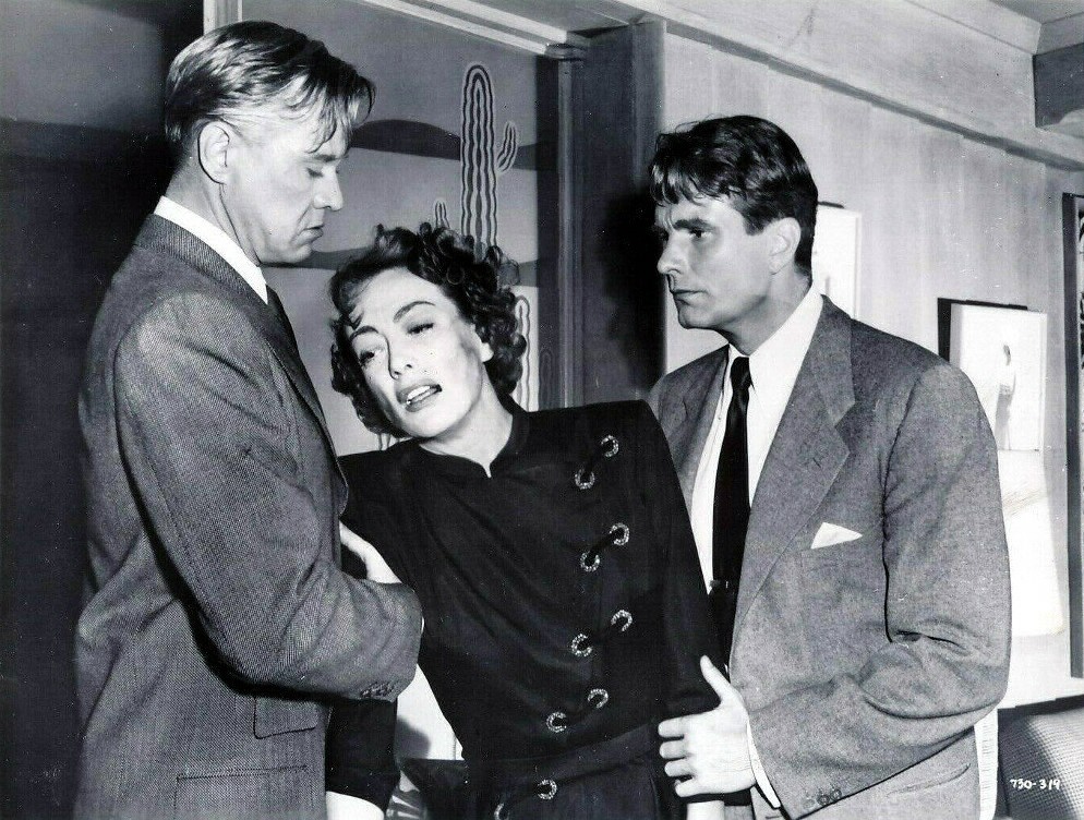 1950. 'The Damned Don't Cry.' With David Brian, left, and Kent Smith.