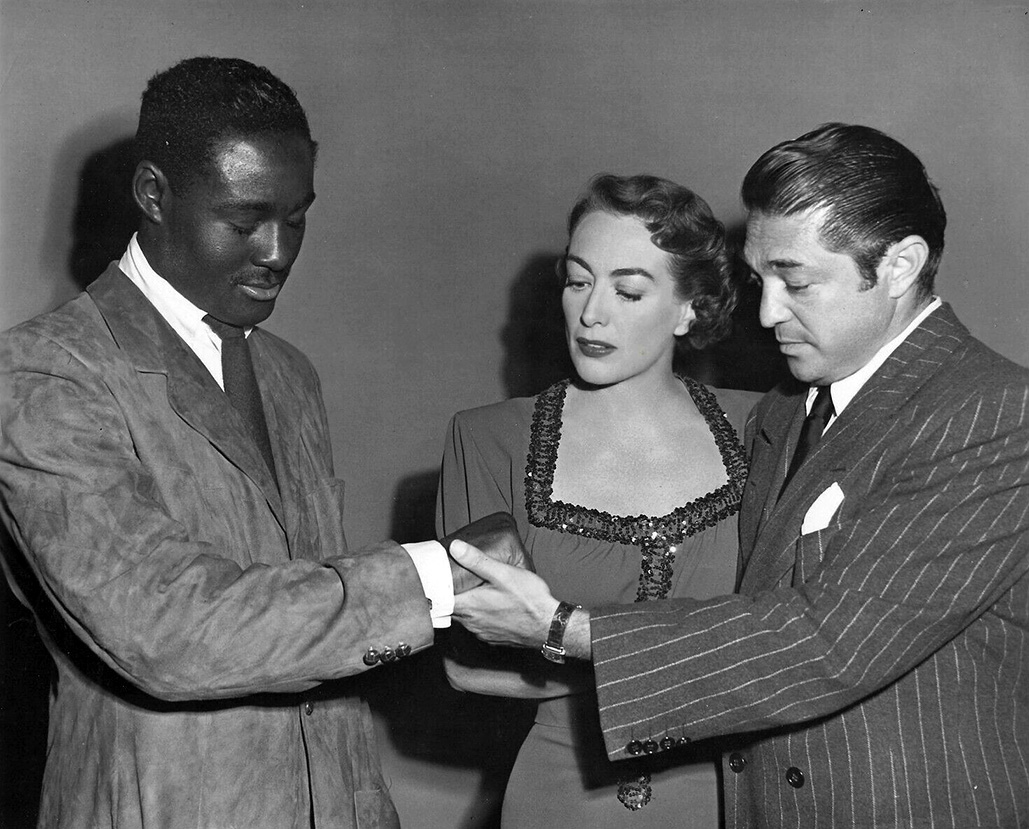 1950. On the set of 'The Damned Don't Cry' with heavyweight champ Ezzard Charles and director Vince Sherman.