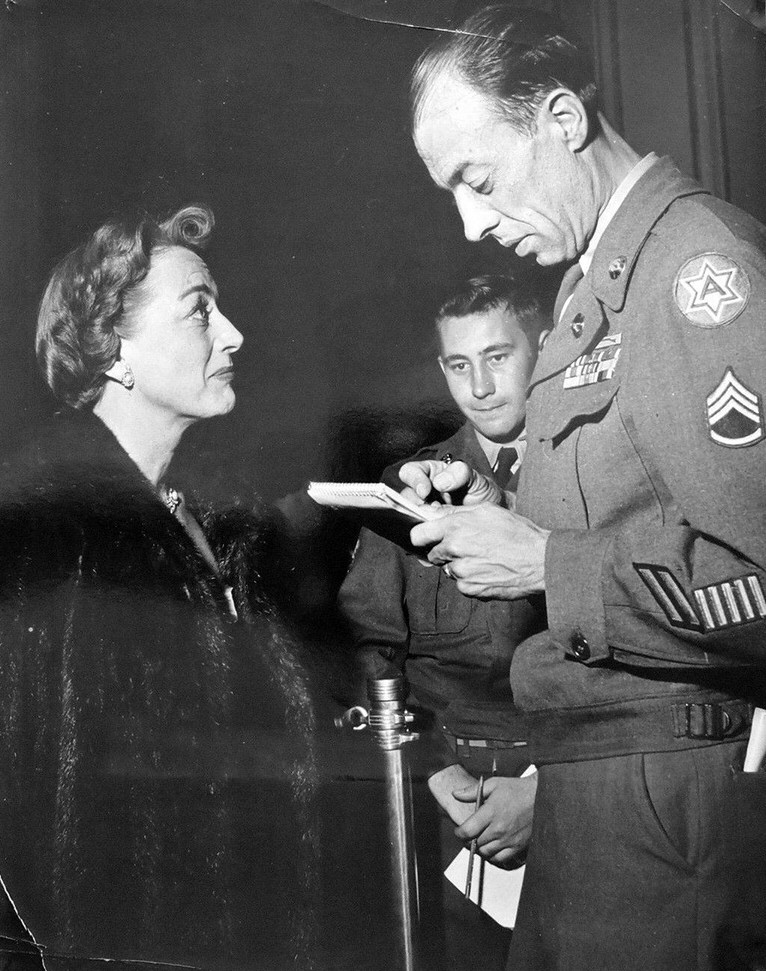 1950. At the 'Breakthrough' premiere being interviewed by 'Armed Forces' reporter.