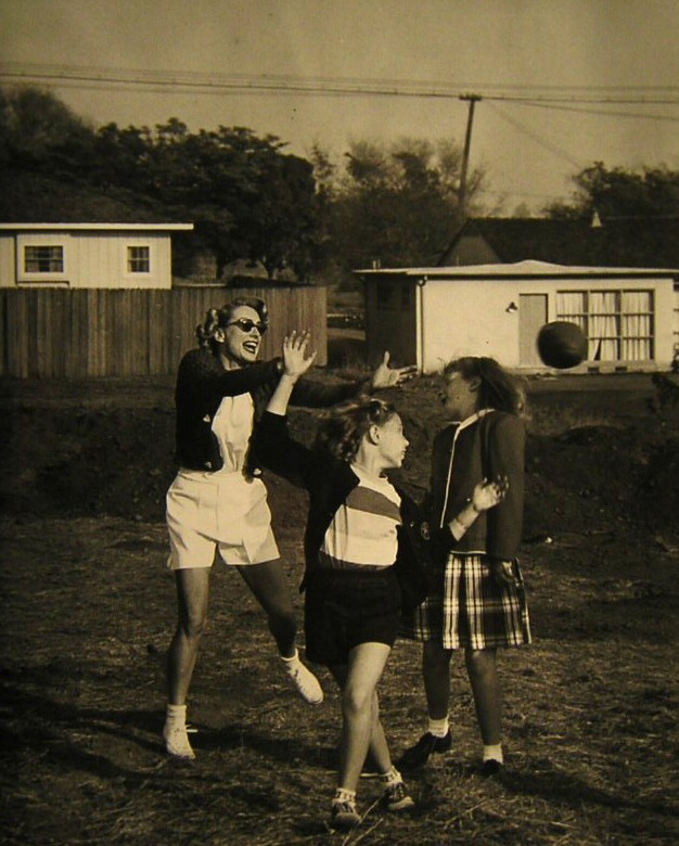 1949. Football with kids.