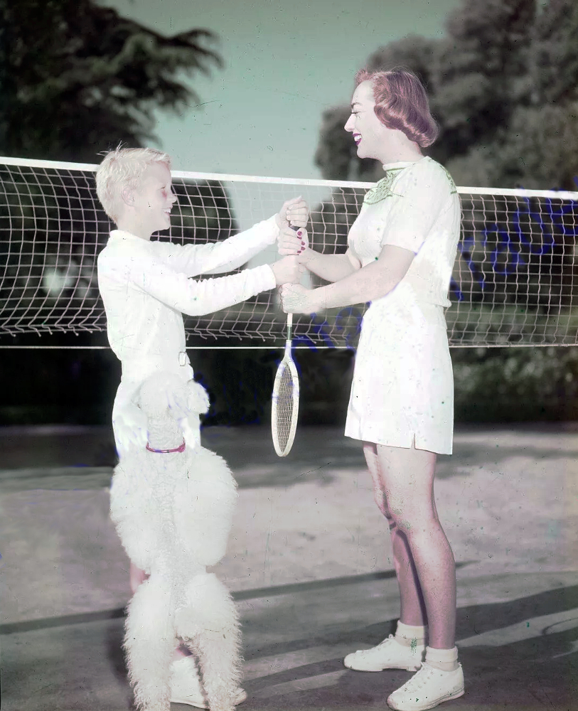 1950. With son Christopher on badminton court. (With Cliquot.)