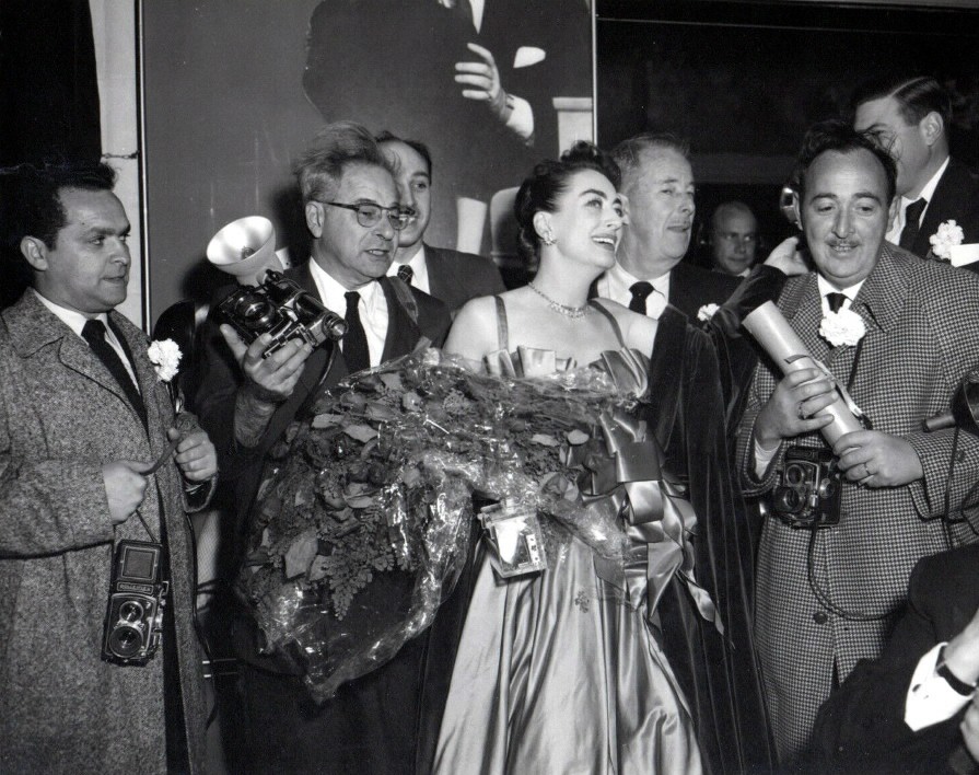 October 1953 with press photogs at 'Torch Song' premiere party.