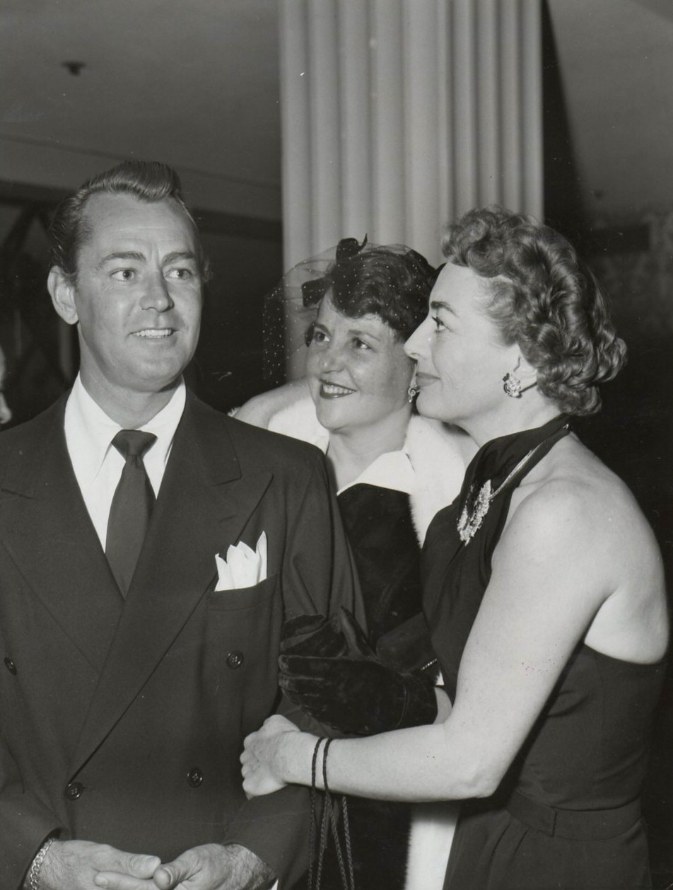 11/30/51. With Alan Ladd and wife at Dinah Shore's party. Photo by Nat Dillinger.