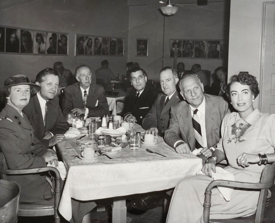 1951. At Warners commissary, planning 'Our America Program.' (Lt. Gov. Goodwin Knight at Joan's right.)