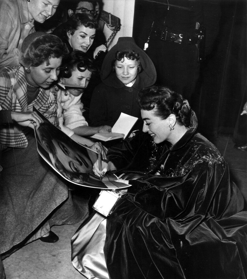 At the November 1953 premiere of 'Torch Song' with fan-club members. Shot by Bob Beerman.