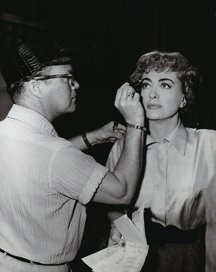 1953. On the set of 'Torch Song' with MGM makeup man Eddie Allen.