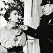 Greeted at the MGM gate by guard Henry Keating. (Includes press caption.)