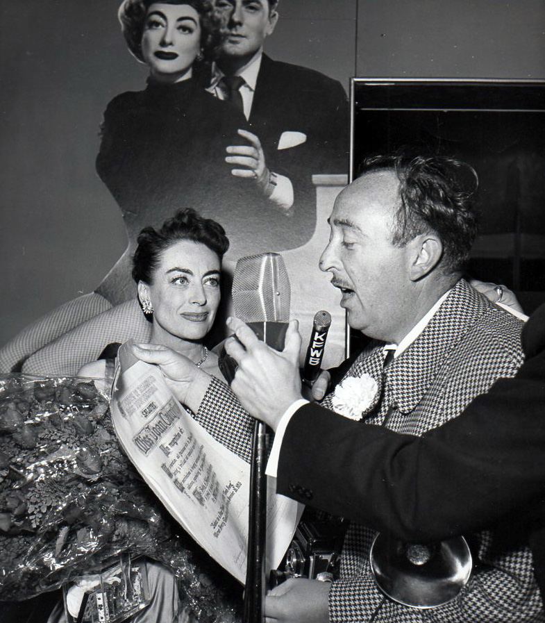 November 1953. Receiving a press photographers' award on the eve of the 'Torch Song' premiere.