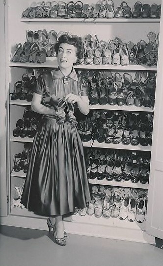 June 1954, at home with her shoes.